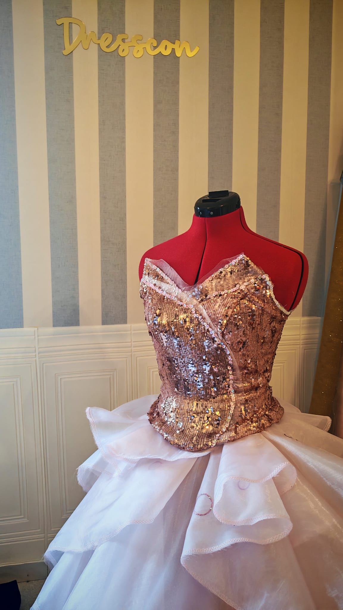 Full view of the pink Glinda-inspired fantasy ball gown featuring a sequined bodice and asymmetrical organza layers.