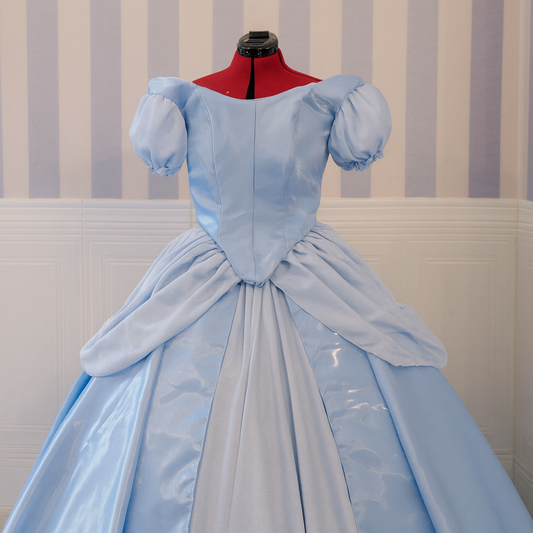 Handmade blue Cindy dress in liquid organza with a flowing skirt and princess-style silhouette.