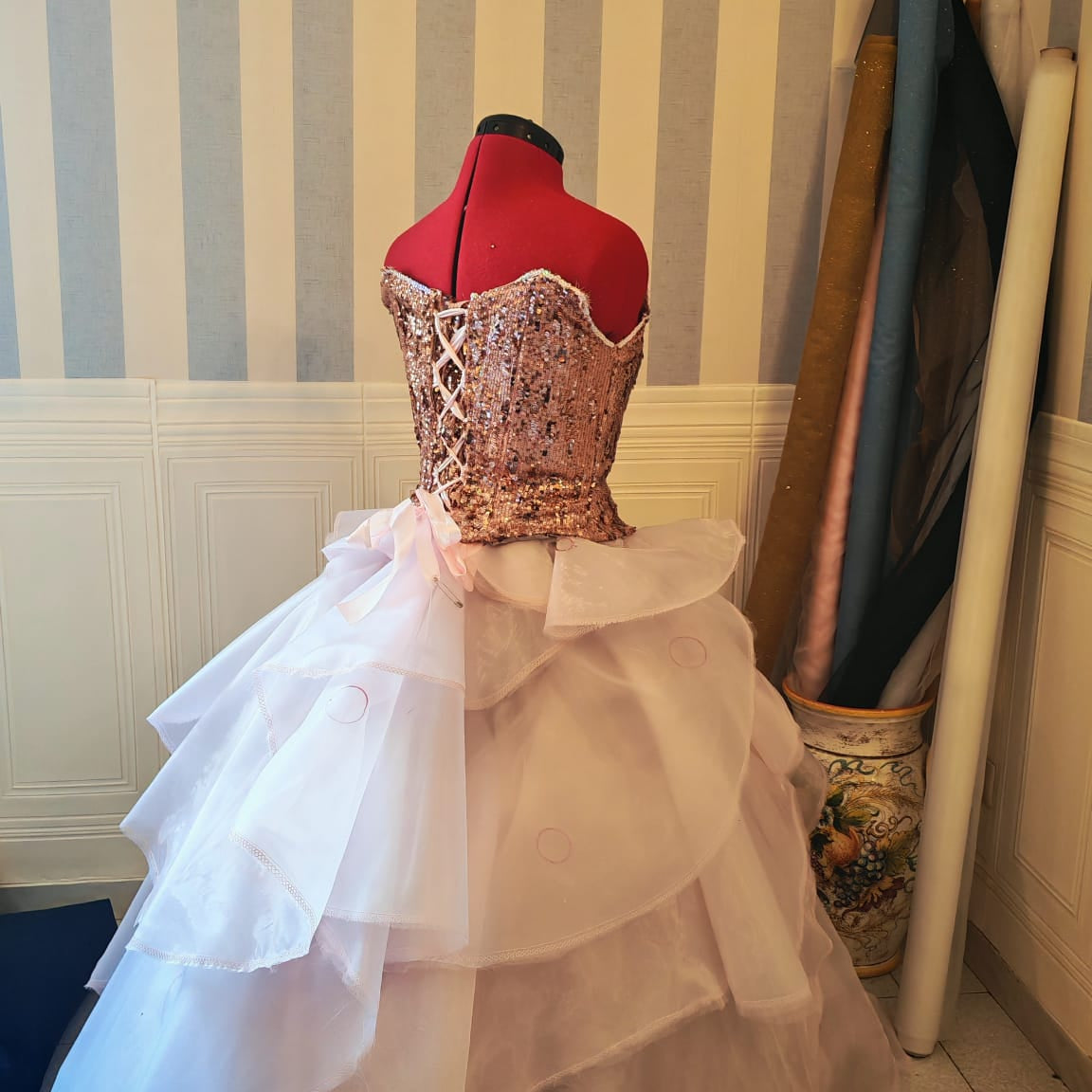 Detailed view of the voluminous pink organza tiered skirt with crinoline for a magical witch cosplay gown.
