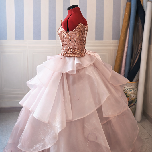 Close-up of a pink sparkling corset bodice with glitter vinyl and sequins for a Glinda-inspired fantasy dress.