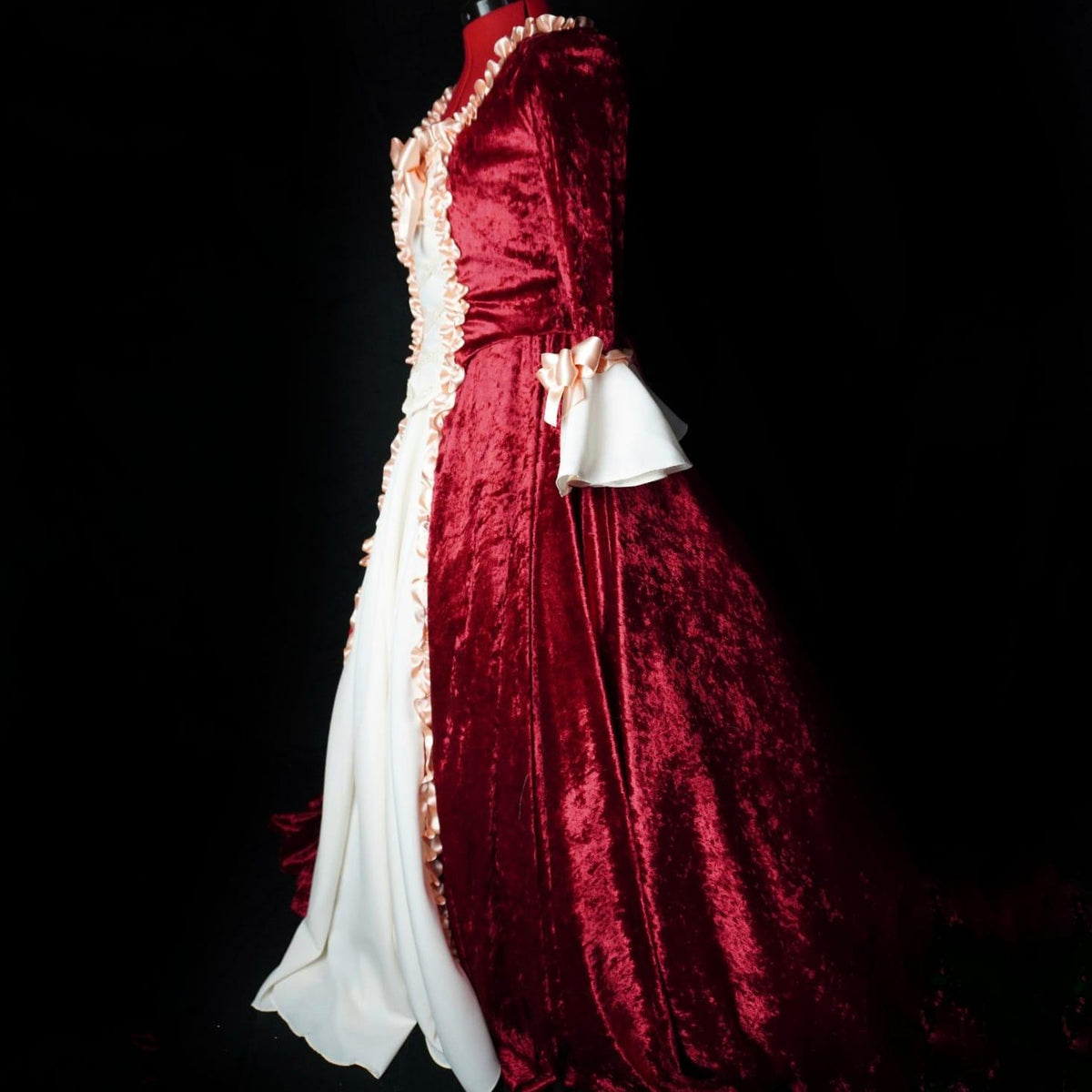 Red velvet Venetian masquerade gown shown from the side