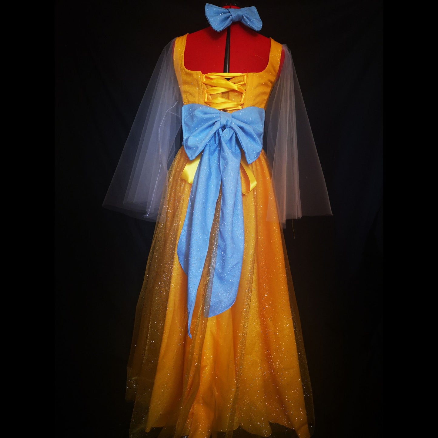 Wide view of the Grand Duchess gown during a waltz twirl, showing the dramatic volume of the floor-length skirt and glittery fabric catching the light.